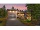 Charming two-story home featuring a dark garage door, a well-kept yard, and a stone chimney at 25531 Mosier Cir, Conifer, CO 80433