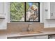 Kitchen sink with a view of mature trees and rock outcroppings at 25531 Mosier Cir, Conifer, CO 80433
