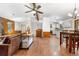 Open-concept living area with wood floors, a comfortable leather sofa, and a staircase leading to the upper level at 25531 Mosier Cir, Conifer, CO 80433