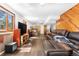Spacious living room features a cozy fireplace, hardwood floors, and comfortable leather seating at 25531 Mosier Cir, Conifer, CO 80433