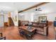 Inviting living room with wood floors, a comfortable leather sofa, and a staircase leading to the upper level at 25531 Mosier Cir, Conifer, CO 80433
