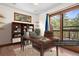 Bright office featuring wood floors, a bookshelf, and a desk, with access to a deck with outdoor views at 25531 Mosier Cir, Conifer, CO 80433