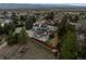 Expansive aerial view of home with tennis court, fire pit and lush surroundings at 6668 Walker Ct, Niwot, CO 80503
