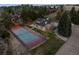 Spacious home with tennis court, lush landscaping, mature trees, and fenced garden area at 6668 Walker Ct, Niwot, CO 80503