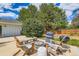 Outdoor seating area with adirondack chairs, a gas grill and a fire pit with mountain views at 6668 Walker Ct, Niwot, CO 80503