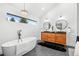 Bright bathroom with a soaking tub, double vanity, and modern lighting at 6668 Walker Ct, Niwot, CO 80503