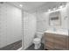 Modern bathroom with subway tile shower, updated vanity, and gray pebble floor at 6668 Walker Ct, Niwot, CO 80503