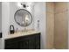 Modern bathroom featuring vanity with sink, round mirror, and tiled shower with glass door at 6668 Walker Ct, Niwot, CO 80503