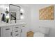 Stylish powder room with a modern vanity, decorative mirror, and contemporary fixtures at 6668 Walker Ct, Niwot, CO 80503