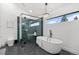 Modern bathroom featuring a glass-enclosed shower and a soaking tub at 6668 Walker Ct, Niwot, CO 80503