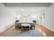 Cozy bedroom with natural light, hardwood floors, and a decorative wall hanging at 6668 Walker Ct, Niwot, CO 80503