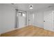 Bright bedroom featuring hardwood floors, a window with curtains, and white walls at 6668 Walker Ct, Niwot, CO 80503