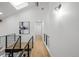 Hallway with hardwood floors, black metal railings, and an art piece at 6668 Walker Ct, Niwot, CO 80503