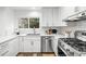 Close up shot of the gorgeous, updated kitchen with a stainless steel gas range and backsplash at 6668 Walker Ct, Niwot, CO 80503