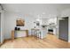 Bright kitchen with modern white cabinetry, stainless appliances, and an eat-in island at 6668 Walker Ct, Niwot, CO 80503