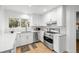 Beautifully renovated kitchen features white cabinets, marble countertops, and stainless steel appliances at 6668 Walker Ct, Niwot, CO 80503