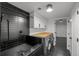 Luxurious laundry room featuring a dog bath, sleek cabinetry, and modern appliances at 6668 Walker Ct, Niwot, CO 80503