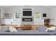 Bright living room featuring a fireplace with a modern tile surround and built-in shelving at 6668 Walker Ct, Niwot, CO 80503