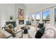 Stylish living room featuring a modern fireplace, hardwood floors, and lots of natural light at 6668 Walker Ct, Niwot, CO 80503