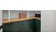Pantry featuring dark green cabinets, wood countertop, and built-in shelving at 6668 Walker Ct, Niwot, CO 80503