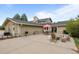 Outdoor patio with fire pit, dining area, grill, and mature landscaping at 6668 Walker Ct, Niwot, CO 80503