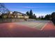 Inviting tennis court with beautiful home and landscaping in the background at 6668 Walker Ct, Niwot, CO 80503