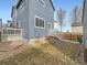 Backyard with a small deck, stairs, and natural landscaping with rocks and foliage at 4723 Crestone Peak St, Brighton, CO 80601