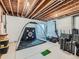 Unfinished basement with a golf simulator, fitness equipment, and ample storage space at 4723 Crestone Peak St, Brighton, CO 80601