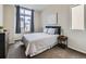 Cozy bedroom with large window, neutral decor, and comfortable queen-sized bed at 4723 Crestone Peak St, Brighton, CO 80601
