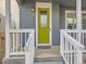 View of the home's entrance with a quaint front porch and a striking green front door at 4723 Crestone Peak St, Brighton, CO 80601