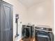 Convenient laundry room with modern washer, dryer, storage and mounted vacuum at 4723 Crestone Peak St, Brighton, CO 80601