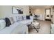 Living room featuring a gray sofa with stylish pillows and decor, adjacent to a work desk at 4723 Crestone Peak St, Brighton, CO 80601