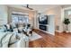 Comfortable living room with an electric fireplace, hardwood floors and a large television at 4723 Crestone Peak St, Brighton, CO 80601