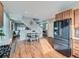 Open-concept living area with modern dining set, stainless steel refrigerator and staircase at 4723 Crestone Peak St, Brighton, CO 80601