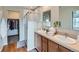 Bright main bathroom with double vanity, glass-enclosed shower, and walk-in closet at 4723 Crestone Peak St, Brighton, CO 80601