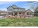 Expansive backyard features a patio area with a fire pit and outdoor seating, surrounded by lush green lawn at 13955 Craig Way, Broomfield, CO 80020