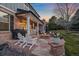 Backyard patio with flagstone pavers, a fire pit, outdoor seating, and landscaping, creating a warm ambiance at 13955 Craig Way, Broomfield, CO 80020