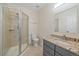 Bathroom featuring a glass-enclosed shower, toilet, vanity with granite countertop, and neutral tile flooring at 13955 Craig Way, Broomfield, CO 80020