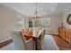 Bright dining room features a wood table, chandelier, and large windows with backyard views at 13955 Craig Way, Broomfield, CO 80020
