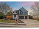 Beautiful two-story home with a well-manicured lawn, brick accents, and a spacious three-car garage at 13955 Craig Way, Broomfield, CO 80020