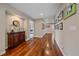 Long hallway with hardwood floors, framed pictures, and neutral wall color throughout at 13955 Craig Way, Broomfield, CO 80020