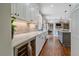 Contemporary kitchen with a wine cooler, white cabinets, and views into the open-concept living area at 13955 Craig Way, Broomfield, CO 80020