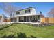 Charming two-story home with a well-maintained front lawn and attached garage at 6087 W 84Th Ave, Arvada, CO 80003