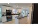 Modern kitchen featuring white cabinets, black countertops, stainless steel appliances, and an island at 6087 W 84Th Ave, Arvada, CO 80003
