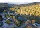 Scenic aerial view of a property surrounded by lush green forests and rolling hills in a mountain community at 5077 Camel Heights Rd # C, Evergreen, CO 80433