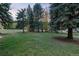 Expansive green lawn and wooded surroundings at 5077 Camel Heights Rd # C, Evergreen, CO 80433