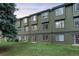 Townhome backyard with green lawn and mature pine trees at 5077 Camel Heights Rd # C, Evergreen, CO 80433