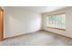 Spacious bedroom features a window for natural light and neutral carpeting at 5077 Camel Heights Rd # C, Evergreen, CO 80433