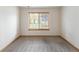 Bright bedroom featuring carpeted floor and a window with wooded blinds at 5077 Camel Heights Rd # C, Evergreen, CO 80433