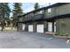 Townhome exterior with garage, balcony, and beautiful landscaping at 5077 Camel Heights Rd # C, Evergreen, CO 80433